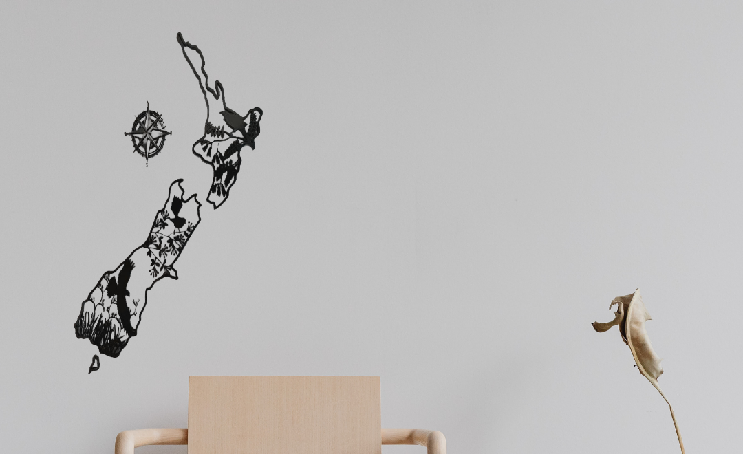 Beige chair against a gray wall with abstract wall art made by aroha artisan