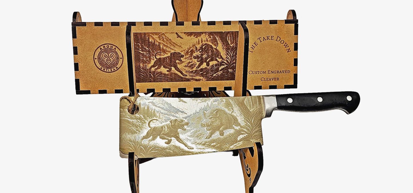 Laser-engraved stainless cleaver — The Take Down — wild boar bush scene — engraved both sides — gift-ready MDF box — Aroha Artisan NZ