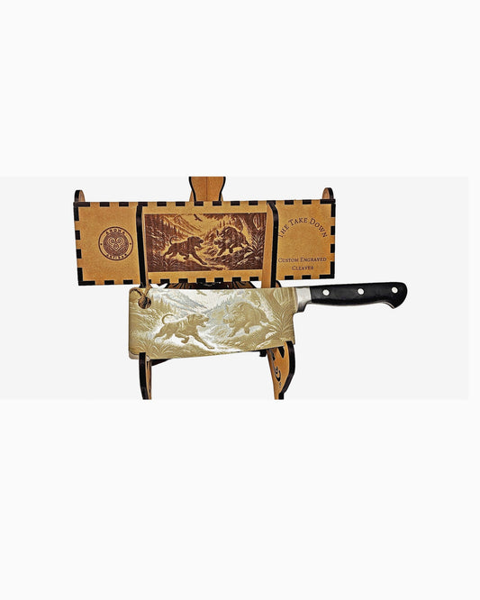 Laser-engraved stainless cleaver — The Take Down — wild boar bush scene — engraved both sides — gift-ready MDF box — Aroha Artisan NZ