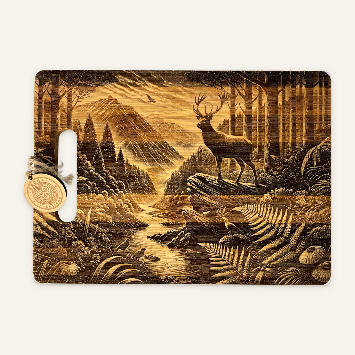 Stag’s Edge engraved wooden board with a stag on a rocky ledge, mountain valley, trees, birds and an Aroha tag on an ivory background.