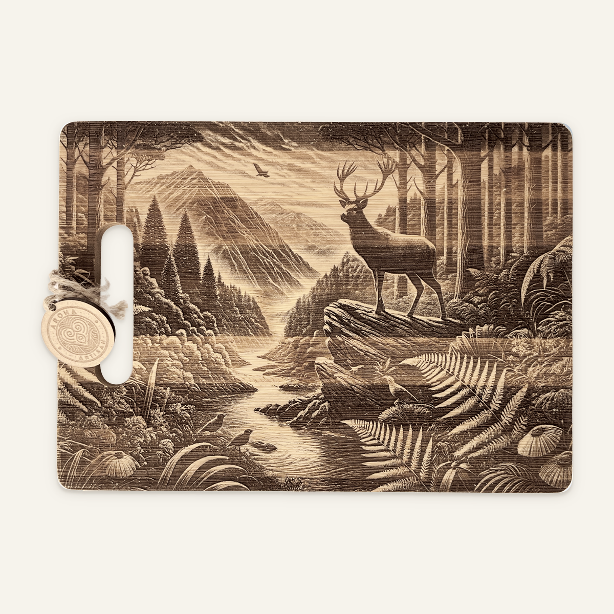 Stag’s Edge engraved wooden board with a stag on a rocky ledge, mountain valley, trees, birds and an Aroha tag on an ivory background.