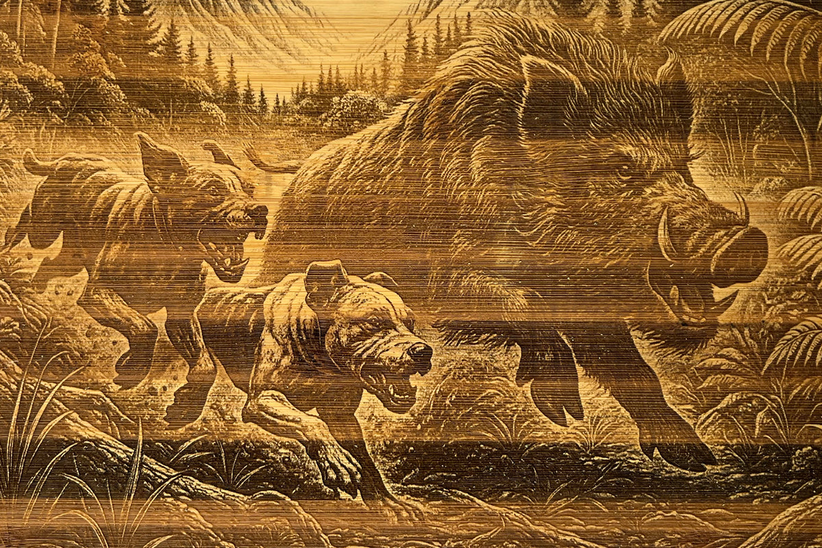 Close-up of The Take Down: Two-Dog Edition bamboo board, showing the engraved chase scene and natural grain.