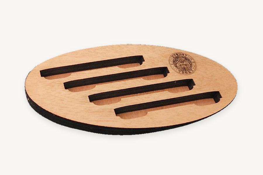 Oval mahogany-clad coaster display stand with four slots and the Aroha Artisan logo