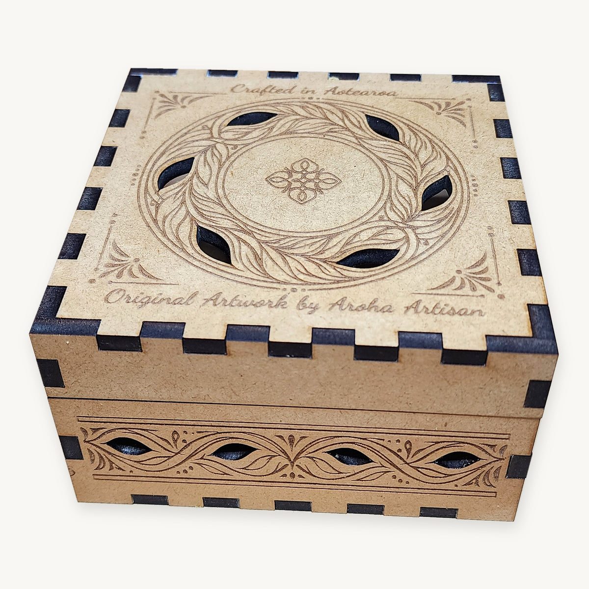 Closed MDF coaster box with an engraved leaf-wreath lid and decorative cut-outs