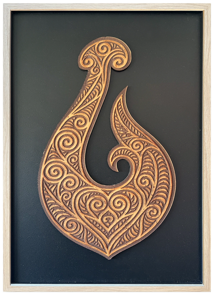 Manaia engraved cutout artwork with black background and Ashwood frame — frame-finish composite and colour visualisation, not a new photograph.