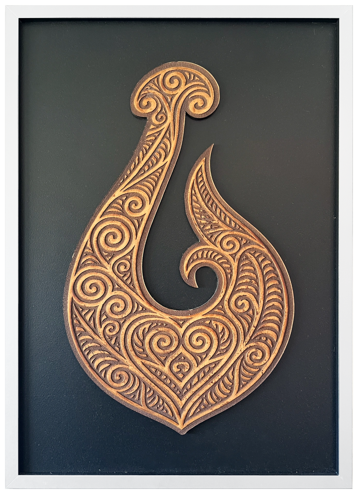 Manaia engraved cutout artwork with black background and White frame — colour visualisation, not a new photograph.