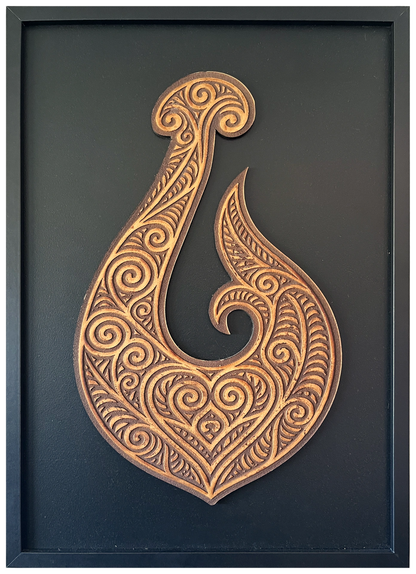Manaia engraved cutout artwork in an A2-size black frame with a black background