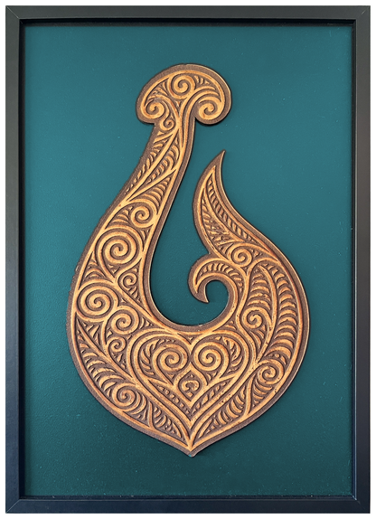 Manaia engraved cutout artwork with teal background and Black frame — colour visualisation, not a new photograph.