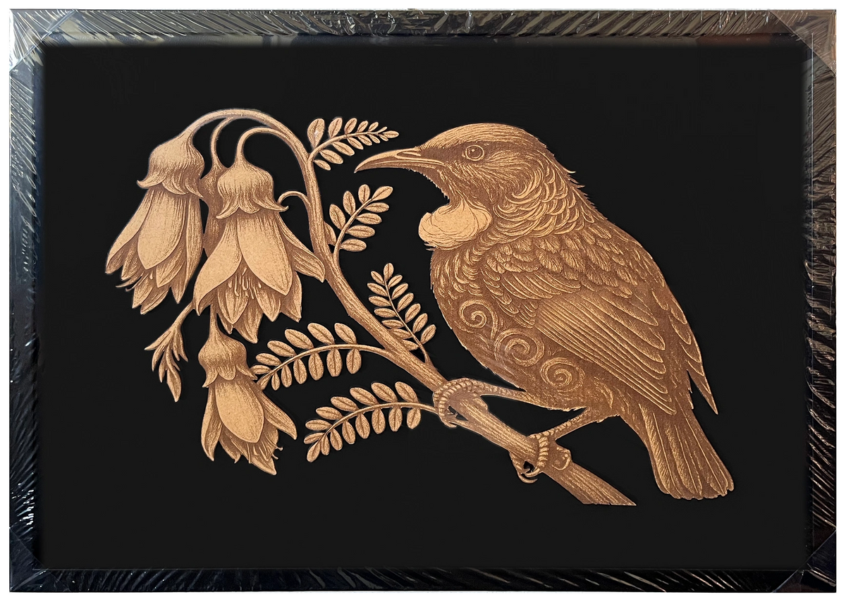 Tūī in Kōwhai Tree engraved cutout artwork in an A2-size black frame with a black background