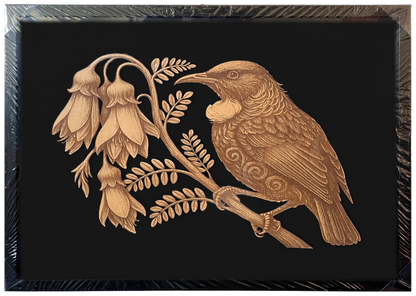Tūī in Kōwhai Tree engraved cutout artwork in an A2-size black frame with a black background